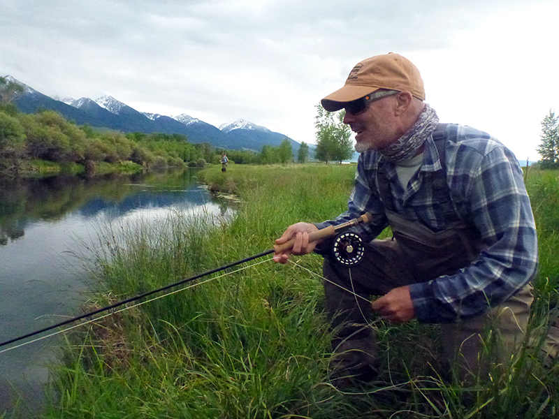 Fly fishing from creek bank.