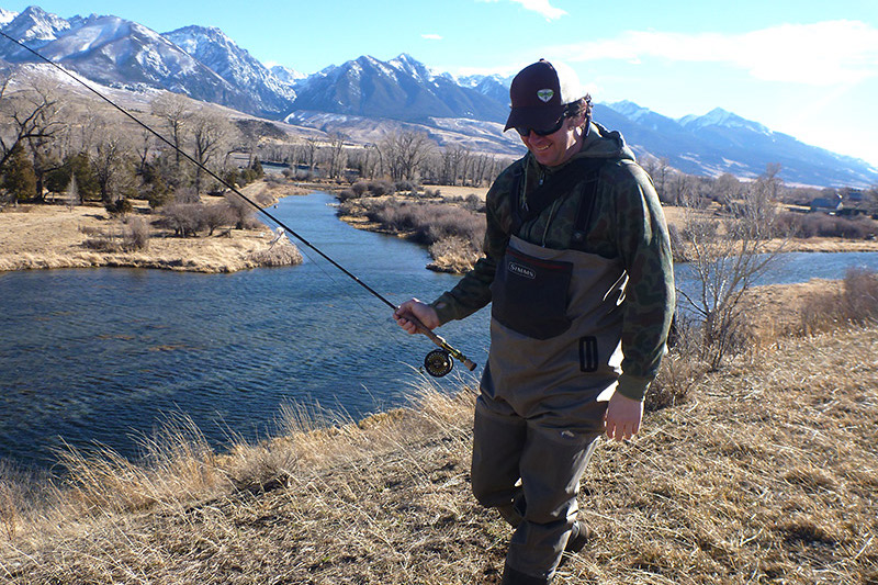 Angler hiking along river