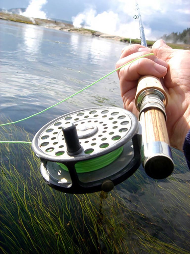 Fly fishing reel and green fishing line