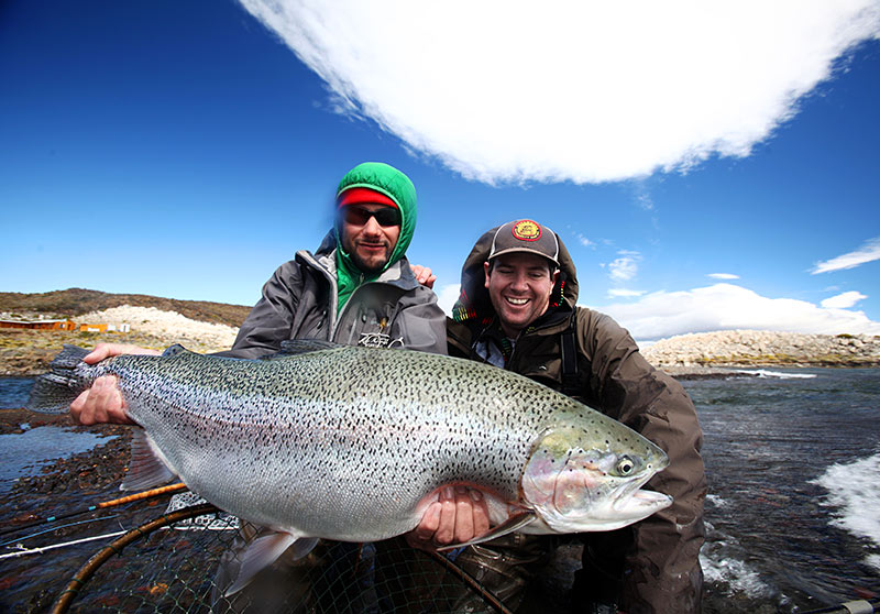 Traveling fishermen pose with catch